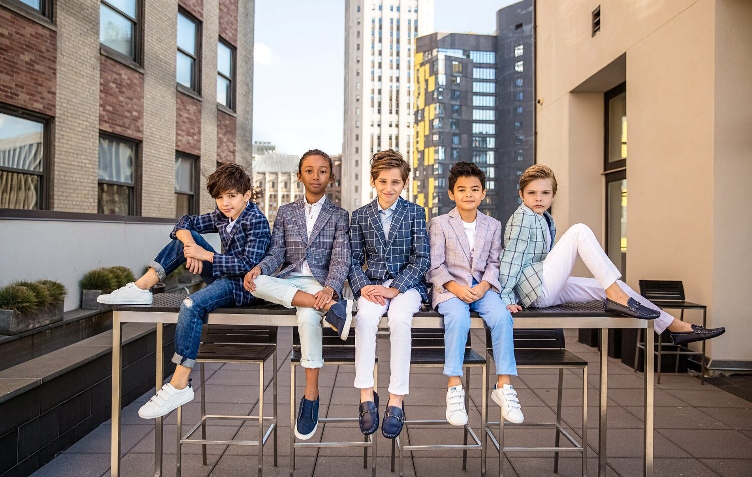 Five boys in Isaac Mizrahi suits on a rooftop