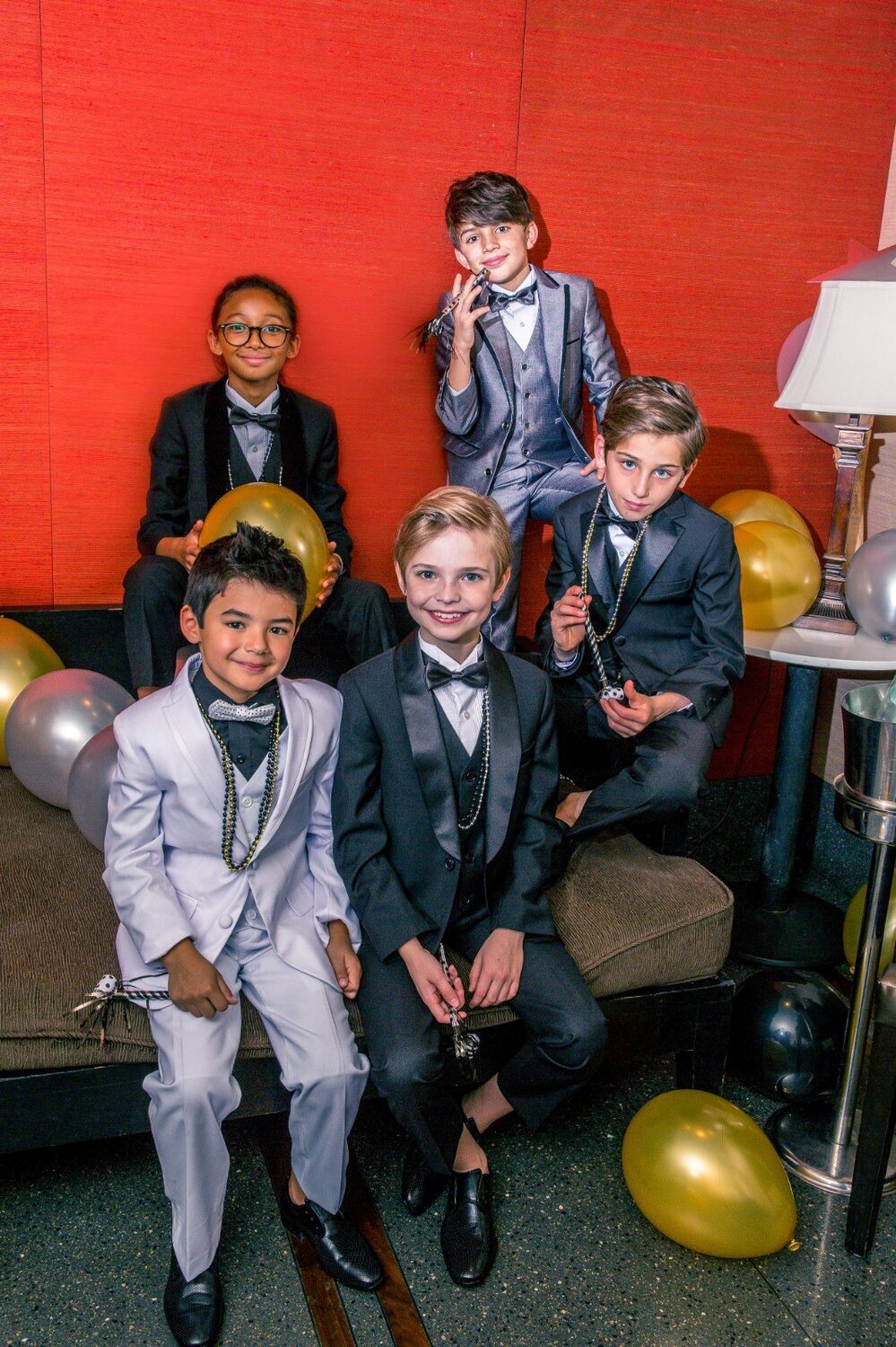 Boys in Isaac Mizrahi suits at a party