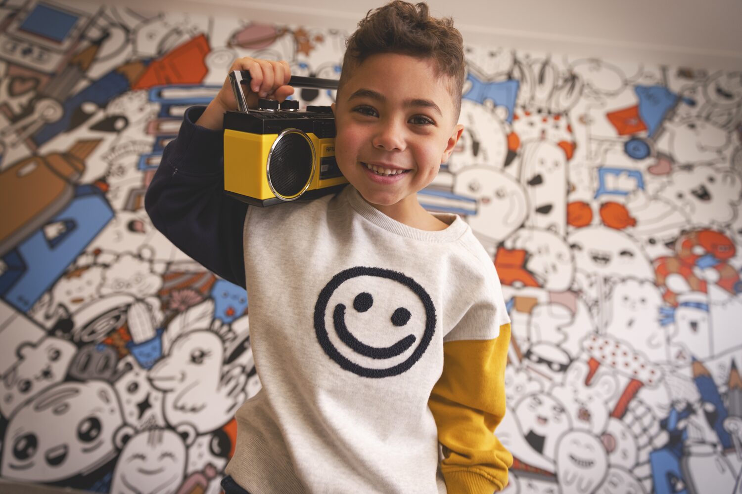 Boy in a Deux par Deux smiley-face sweater