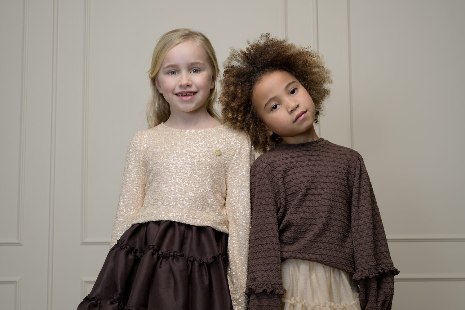 Two girls in Le Chic sequin and knit looks