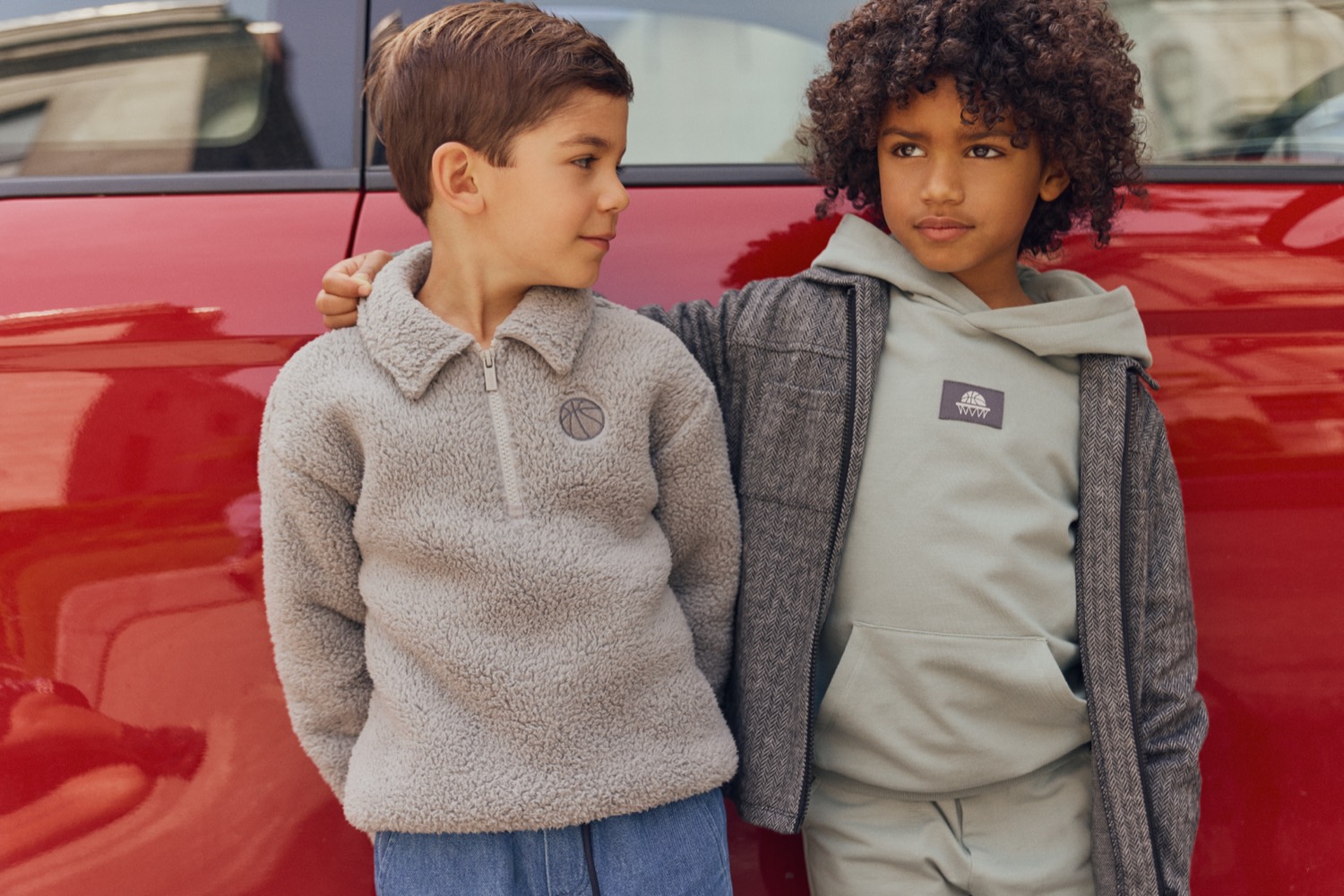 Two boys in a Miles The Label sherpa quarter-zip and sage hoodie set