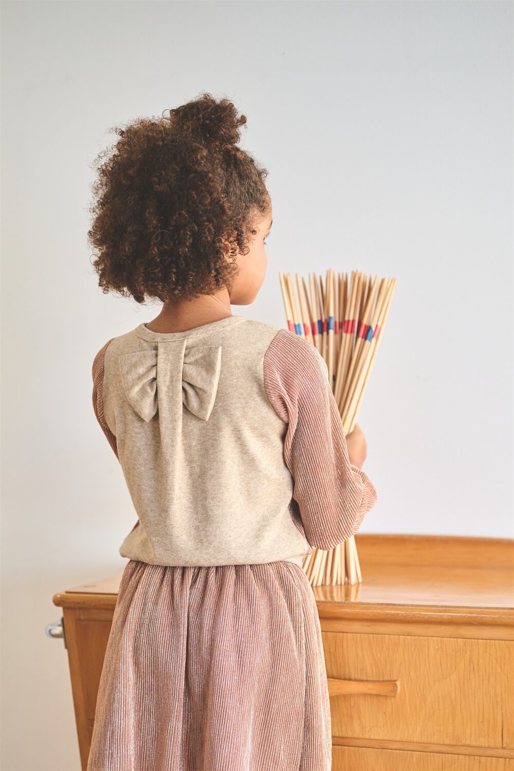 Girl in a NONO knit set, back view