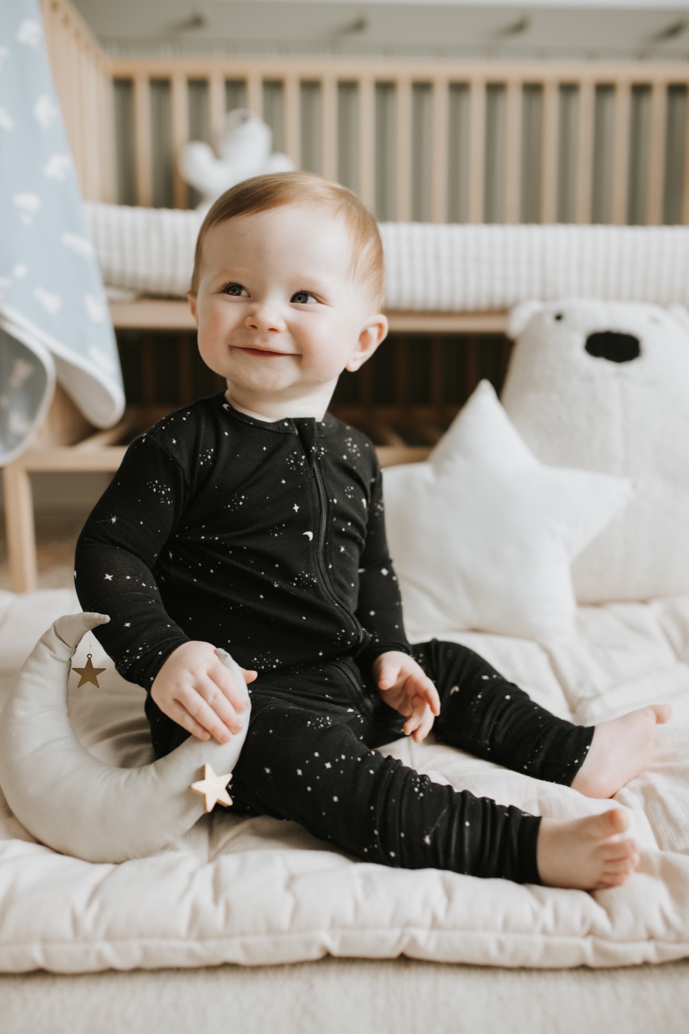 Baby in a Petit Lem black star-print zip sleeper