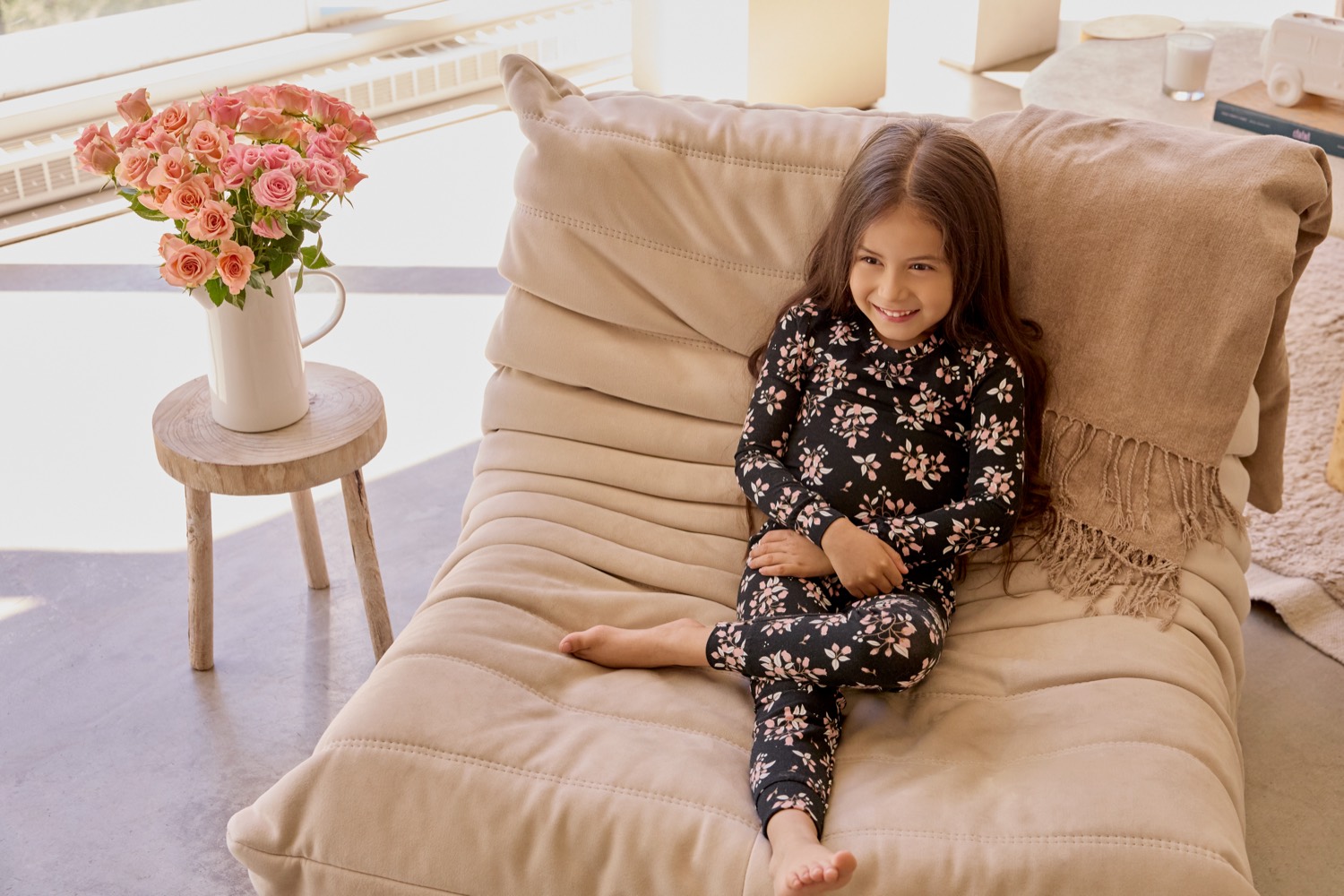 Girl in Petit Lem black floral pyjamas