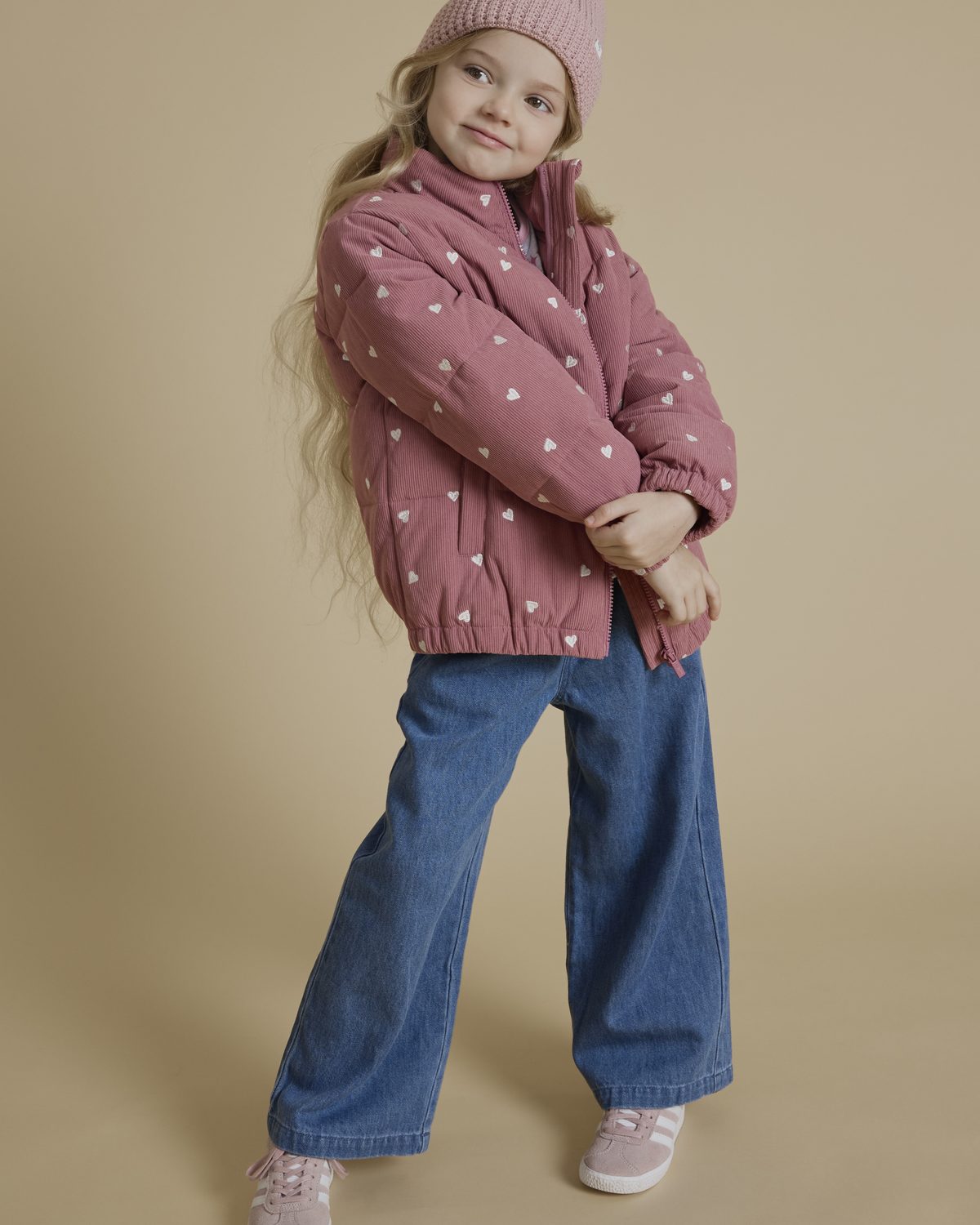 Girl in a Miles The Label heart-print puffer jacket and wide-leg jeans