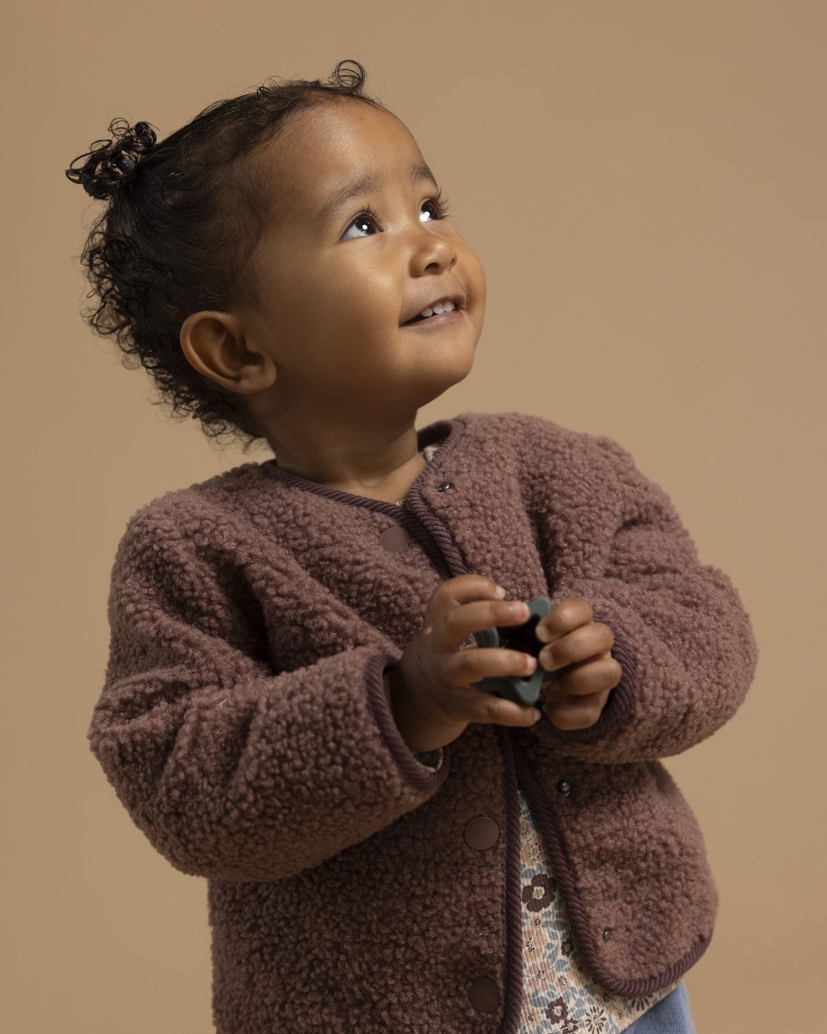 Toddler in a Noppies brown teddy-fleece jacket